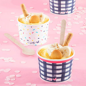 Paper treat cups with dessert in them