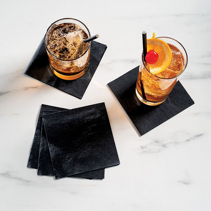 Black napkins with drinks sitting on top