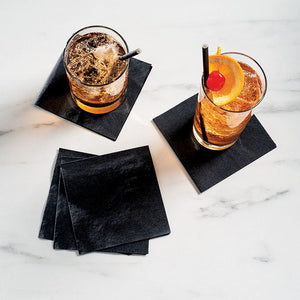 Black napkins with drinks sitting on top